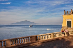 photo of aerial panorama of high cliffs, Tyrrhenian Sea Bay with pure azure water, floating boats and ships, pebble beaches, rocky surroundings of Meta in Sant'Agnello and Sorrento cities near Naples region in Italy.