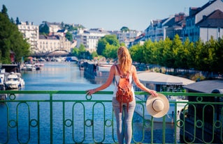 Photo of Vannes, beautiful city in Brittany, boats in the harbor, with typical houses and the cathedral in background, France.