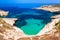 Photo of crystal clear turquoise water in blue lagoon of St. Peters pool  rocky beach at Malta.