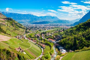 Photo of aerial view of Verona historical city centre, Ponte Pietra bridge across Adige river, Verona Cathedral, Duomo di Verona, red tiled roofs, Veneto Region, Italy.