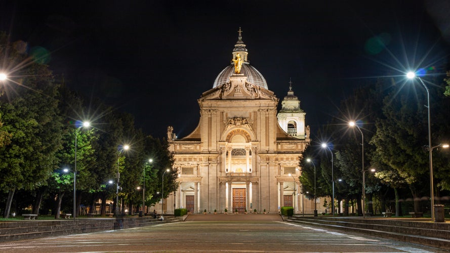 Photo of iIluminated facade of the Papal Basilica of Saint Mary of the Angels in Santa Maria degli Angeli, Assisi, region of Umbria, Italy.