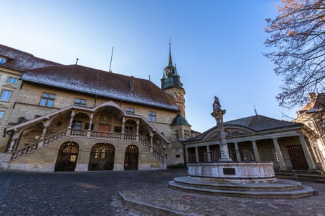 Photo of Fribourg (Freiburg) city hall (twon hall) on a sunny winter day in the center of old town, with blue sky in background, Canton of Fribourg, Switzerland.