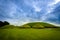 photo of view of Knowth tumulus in the historical area of Brú na Bóinne, Irland.