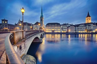 Panoramic view of historic Zurich city center with famous Fraumunster, Grossmunster and St. Peter and river Limmat at Lake Zurich on a sunny day with clouds in summer, Canton of Zurich, Switzerland