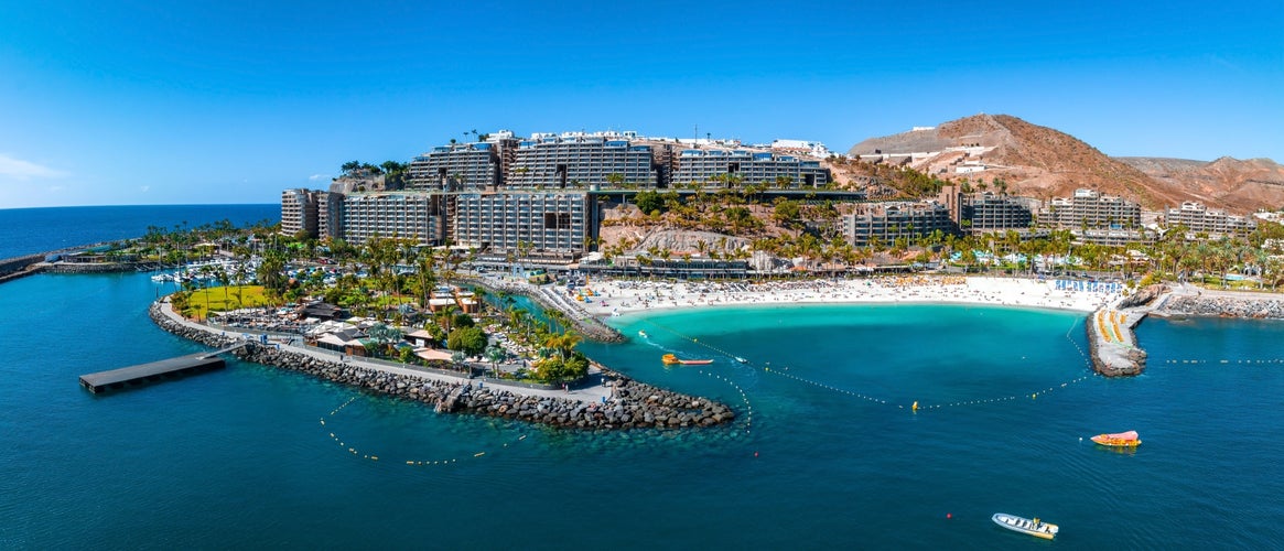 Beautiful aerial landscape with Anfi beach and resort, Gran Canaria, Spain. Luxury hotels, turquoise water, sandy beaches in Spain. Luxury beach vacation concept. Heart shaped island.