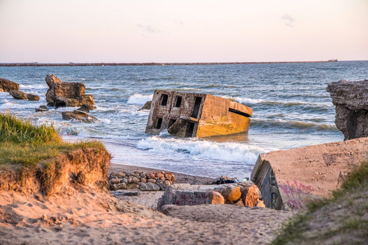 photo of view of Liepaja beach bunker. Abandoned military ruins facilities in a stormy sea. Barracks building in the Baltic sea. Liepaja, Latvia