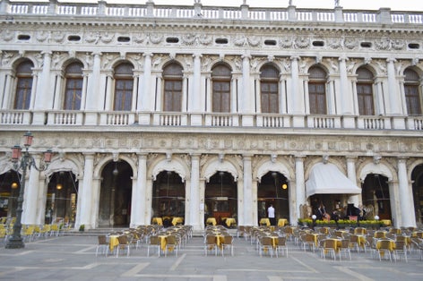 photo of Tourist site of St Mark's Square in Venice, Italy, tall St Mark's tower, the San Marco Basilica cathedral and other baroque and gothic sites in the most famous piazza in the city of Venezia.