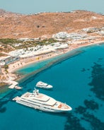 Photo of panoramic aerial view of the popular Platis Gialos beach on the Greek island of Mykonos with turquoise sea, Greece.