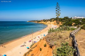 Photo of wide sandy beach in white city of Albufeira, Algarve, Portugal.