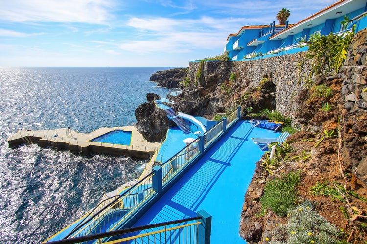 Caniço, Madeira - Outdoors swimming pool on a multi-level terrace among the coastal lava rocks of CaniÃ§o on the southern coast of Madeira island (Portugal) near Funchal