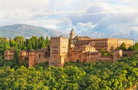 Photo of aerial view of Jaen with cathedral and Sierra Magina mountains on background, Andalusia, Spain.