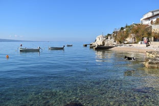 Photo of panorama and landscape of Makarska resort and its harbour with boats and blue sea water, Croatia.