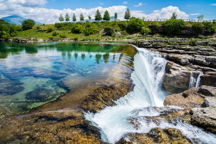 Photo of spectacular waterfall in Podgorica, called Niagara falls of Cijevna river azure waters in untouched green nature scenery, Montenegro.