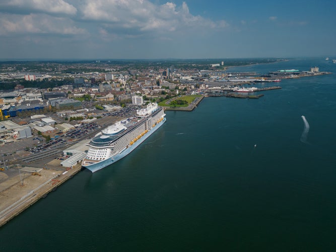 photo of view of  Large cruise ship moored at Southampton UK. Panoramic view of the Southampton city and the docks towards an open sea waters. High altitude aerial on a sunny day.