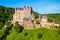 photo of view Eltz Castle or Burg Eltz is a medieval castle in the hills above the Moselle River near Koblenz in Germany.