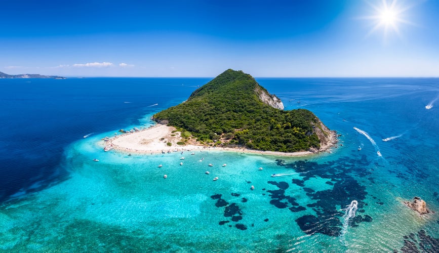 Photo of beautiful island of Marathonisi or Turtle island in the bay of Laganas with turquoise sea and sand beaches, Zakynthos, Greece.