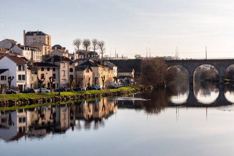 photo of view of View on the quays of Limoges, France. Photographed in autumn and in the evening. View of a bridge and the Vienne River. Reflection on the water.
