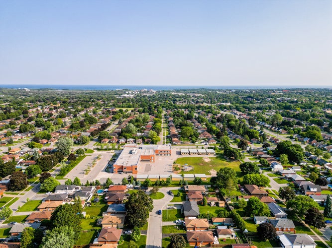 photo of view of Explore Oshawa, Ontario with stunning drone photography. Capture striking aerial views of Lake Ontario, Lakeview Park, and Highway 400. Highlight Durham's real estate market, featuring exquisite homes