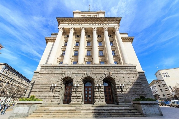 Sofia-s Parliament building with grand neoclassical architecture featuring tall columns, ornate details, and three large wooden doors..jpg