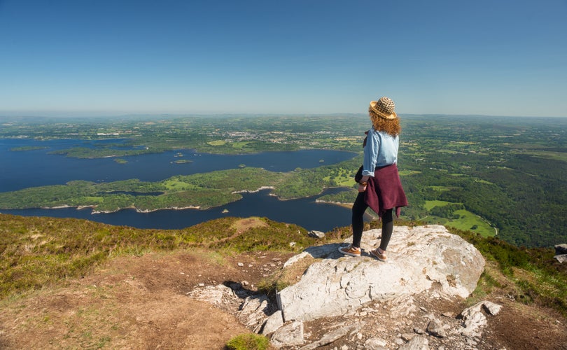 Viewing the green landscape of county Kerry from the top of the Torc mountain