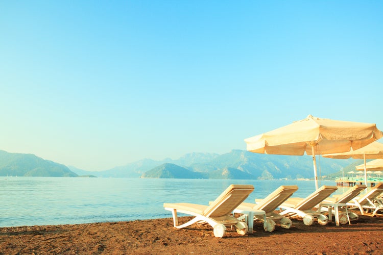 Photo of chaise lounge on the beautiful sandy beach in Marmaris, Turkey.