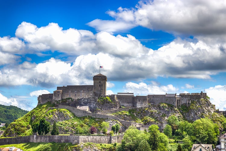 Photo of Chateau Fort on a cloudy sky background. Lourdes, Pyrenees, France.