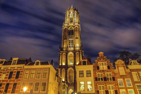 photo of Dom Tower of Utrecht at night in the Netherlands.