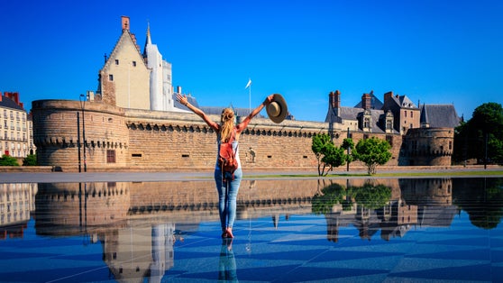 Photo of happy woman enjoying water mirror in Nantes city, France.