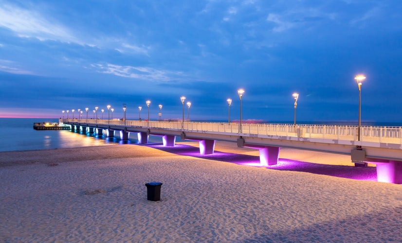 Miedzyzdroje, Poland - Miedzyzdroje pier, long wooden jetty entering the Baltic Sea from the beach, beautiful seaside landscape. Empty beach because of off season