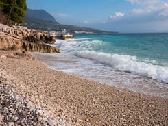 Photo of panorama and landscape of Makarska resort and its harbour with boats and blue sea water, Croatia.