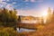 Picturesque autumn landscape with yellow trees, blue cloudy sky and reflection in the water, National park Slovak paradise, Slovakia