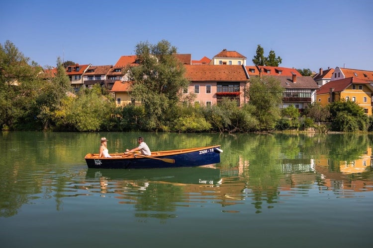 photo of old Houses in Novo Mesto Slovenia at Krka River in Sunny Day.