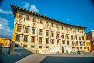 Photo of Italy Piazza Maggiore in Bologna old town tower of town hall with big clock and blue sky on background, antique buildings terracotta galleries.