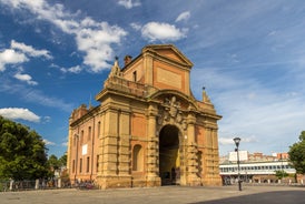 Photo of Italy Piazza Maggiore in Bologna old town tower of town hall with big clock and blue sky on background, antique buildings terracotta galleries.