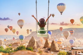 Hot air balloons flying over Uchisar Castle. Cappadocia. Nevsehir Province. Turkey.