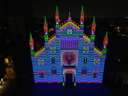Aerial view of facade of the ancient Duomo in Monza (Monza Cathedral). Drone photography of the main square with church in Monza in north Italy, Brianza, Lombardia. Lights and video mapping.