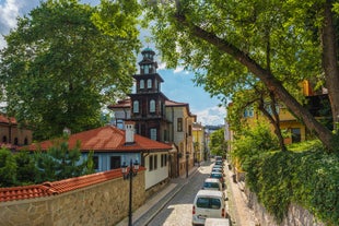 photo of an aerial view of the town of Dryanovo, Bulgaria, with churches Saint Nikola and Sveta Troitsa. Roofs of houses and public buildings and streets from above.