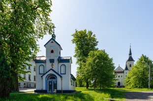 Photo of Lednice Chateau with beautiful gardens and parks on a sunny summer day, Czech Republic.