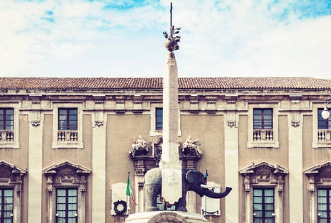 photo of view of Sicily sunset with famous landmark on main square Piazza del Duomo in Catania, monument The Elephant's fountain (Fontana dell'Elefante) on main square Piazza del Duomo, Cagliari, Italy.