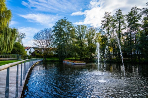 Germany, Beautiful public park feuersee in schorndorf city with a small lake and fountains surrounded by trees