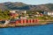 Photo of red houses facades reflecting on the bay of Alta, Norway.