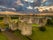 photo of Aerial view of Roscommon castle in Ireland, Anglo Norman stronghold with quadrangular shape with large round towers on the corners with dramatic colorful sunset sky .