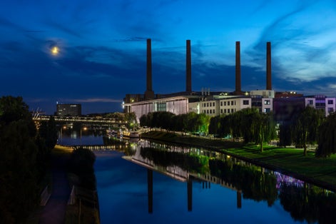 photo of view  of Car plant by canal in Wolfsburg in moon light.