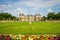 Photo of Luxembourg gardens and palace with puffy clouds in Paris, France.