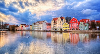 Photo of scenic summer view of the German traditional medieval half-timbered Old Town architecture and bridge over Pegnitz river in Nuremberg, Germany.