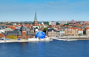 Scenic summer view of Nyhavn pier with color buildings, ships, yachts and other boats in the Old Town of Copenhagen, Denmark