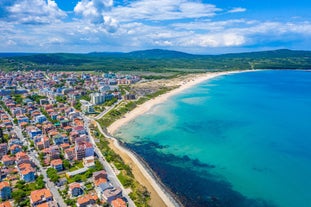 Photo of Saint Anastasia Island in Burgas bay, Black Sea, Bulgaria. Lighthouse tower and old wooden buildings on rocky coast.