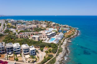 Photo of aerial view of Malia beach and small island with Church of Transfiguration, Heraklion, Crete, Greece.