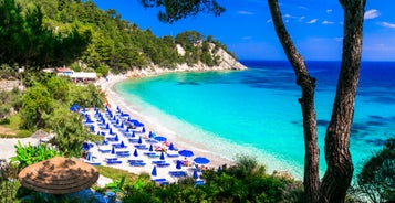 Photo of aerial view of Pythagorio port with colourful houses and blue sea, Samos island, Greece.