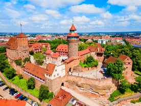 Photo of aerial panoramic view of Hohes Schloss Fussen or Gothic High Castle of the Bishops and St. Mang Abbey monastery in Fussen, Germany.